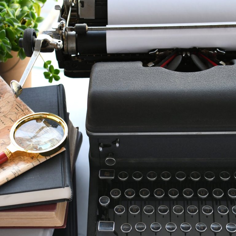 vintage-manual-typewriter-on-desk-with-books-wri-2025-03-11-18-25-33-utc